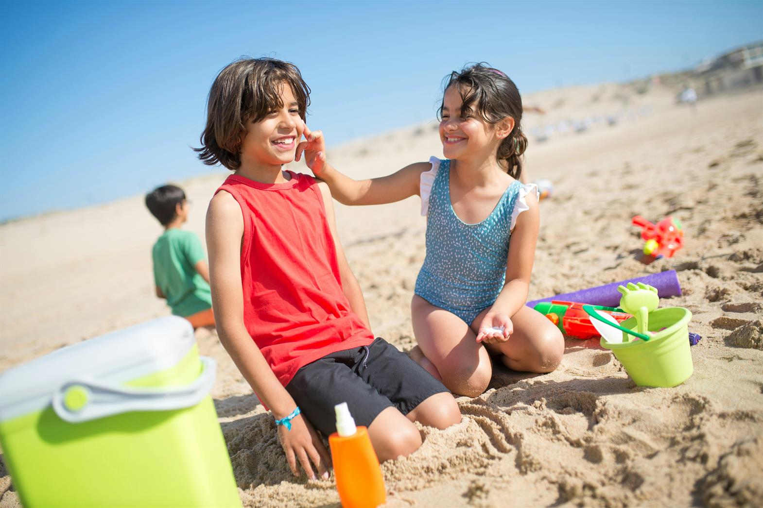 Young Girl Putting Sunscreen on a Boy