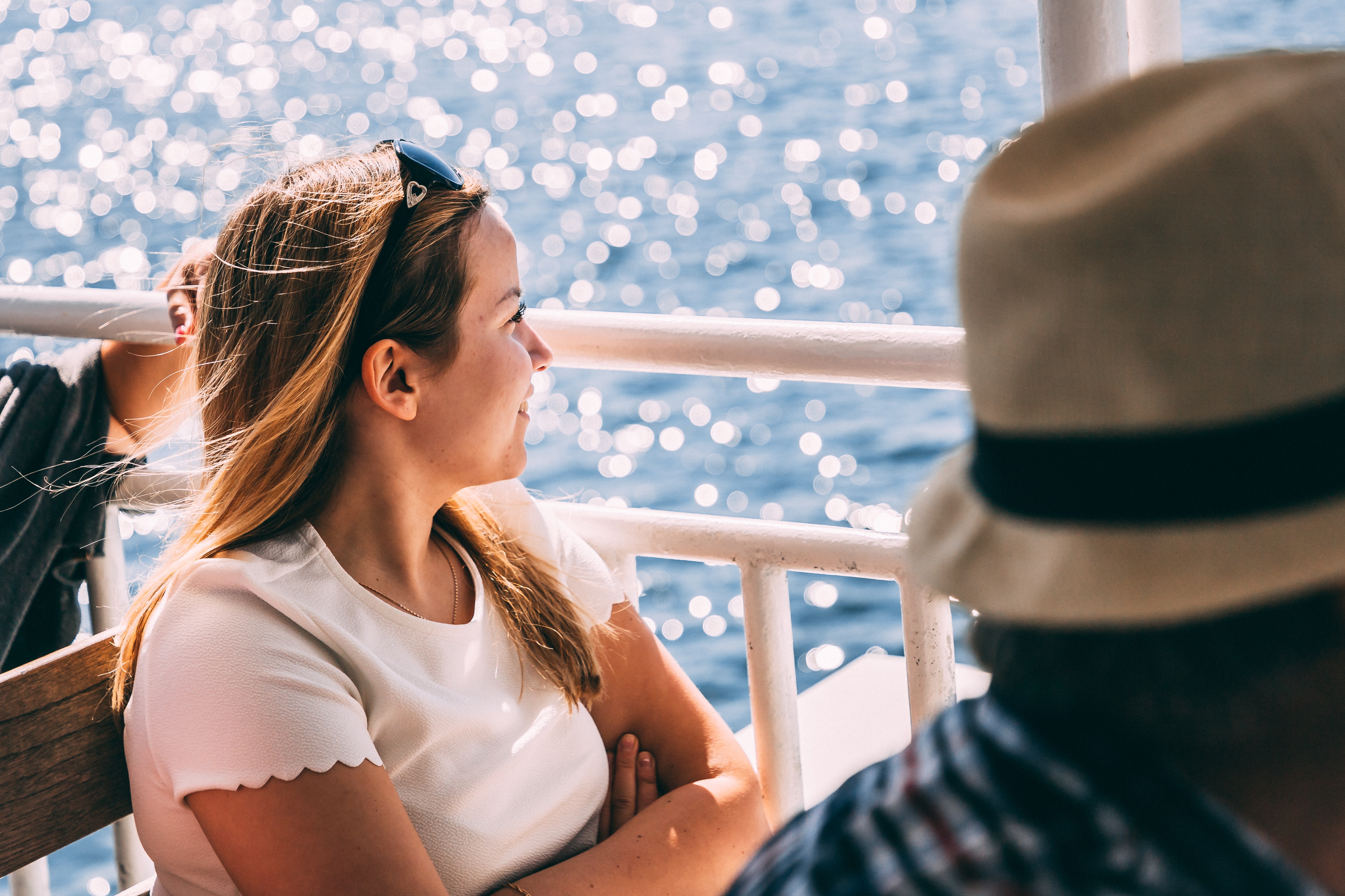 a woman sitting on a ferry looking out over the water
