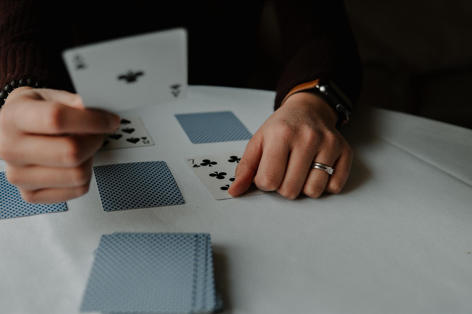 person holding playing cards