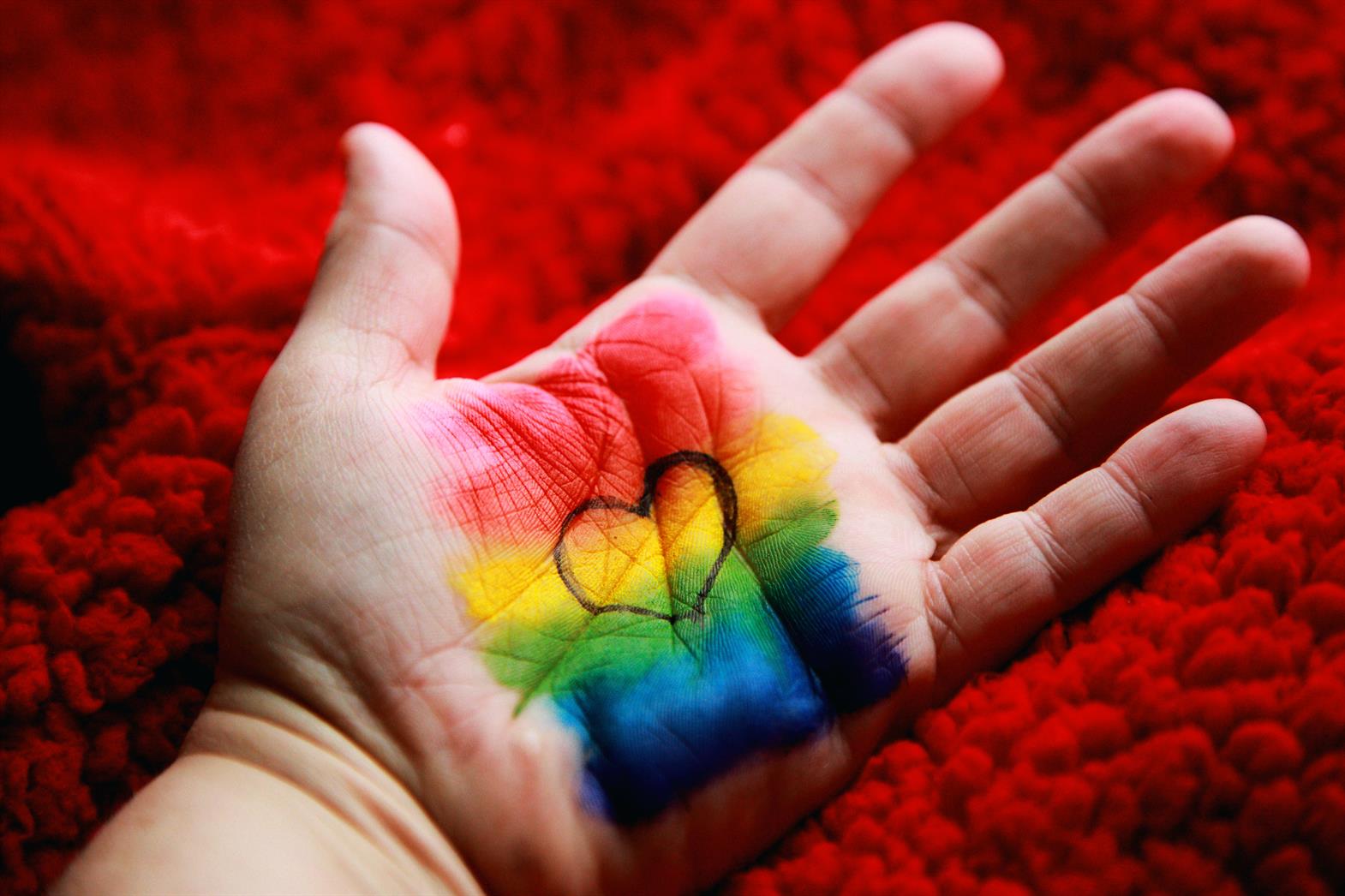 Hand with rainbow and heart