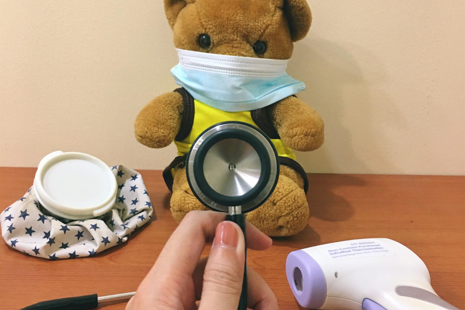 brown bear plush toy beside stehoscope