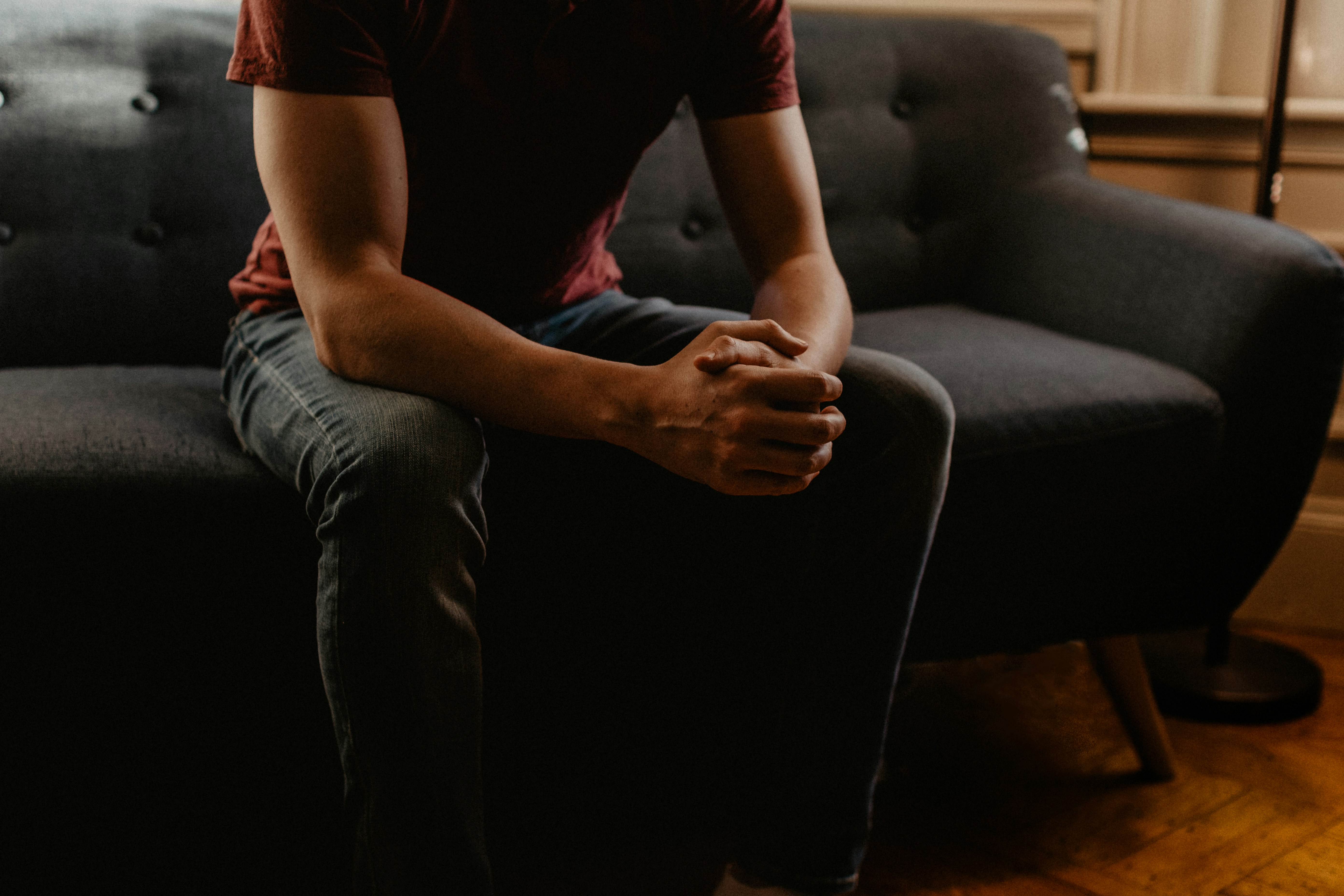 Photo of man sitting on sofa